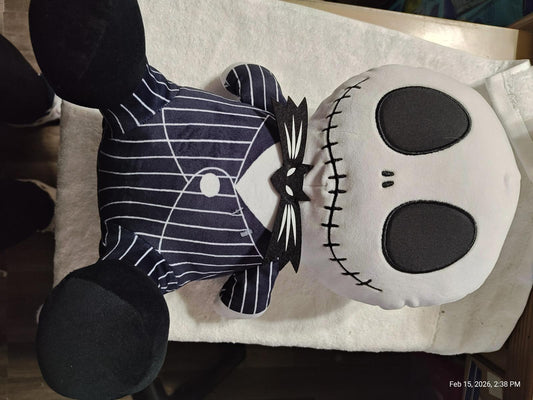 Jack Skellington plush toy with pinstripe suit and large skull face.
