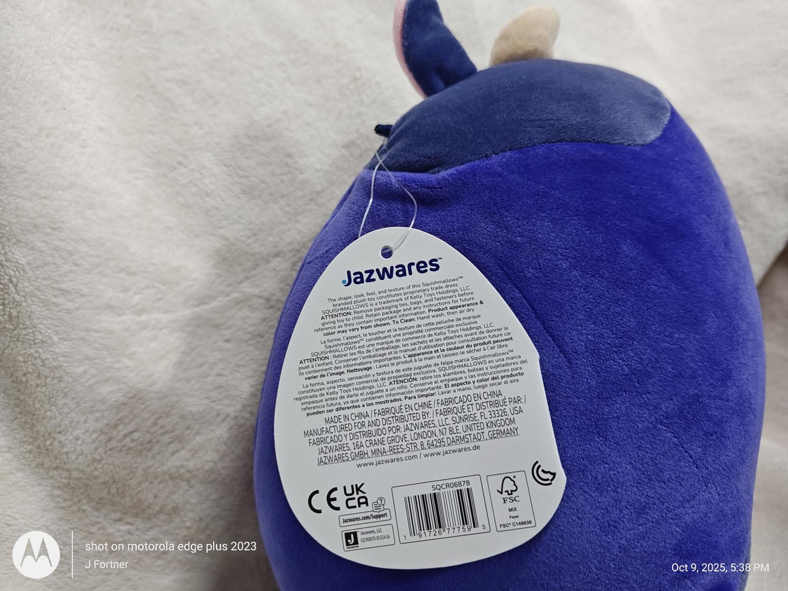 Jazwares plush toy featuring a purple design with a tag detailing care instructions.