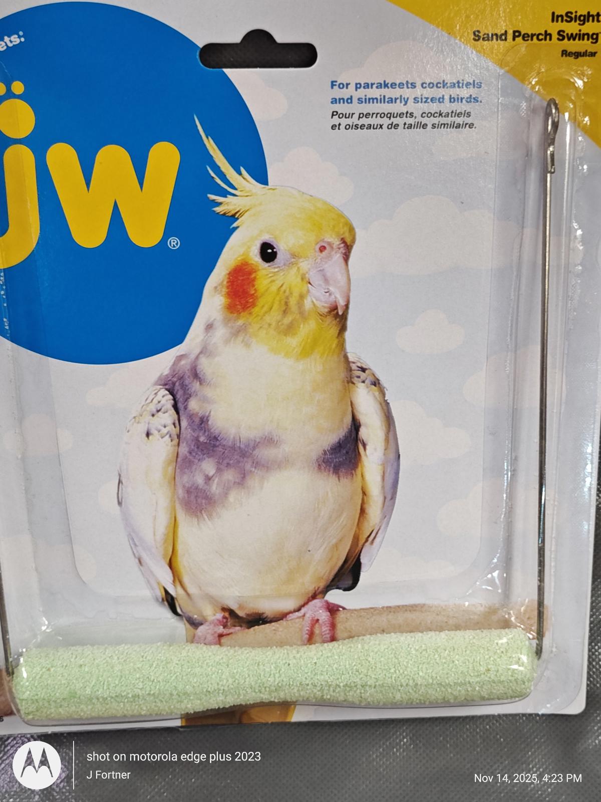 JW Insight Sand Perch Swing for birds, featuring a soft green surface and a cockatiel perched on it.