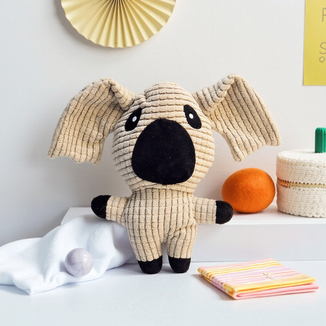 Koala plush toy with textured fabric and large ears, perfect for cuddling.