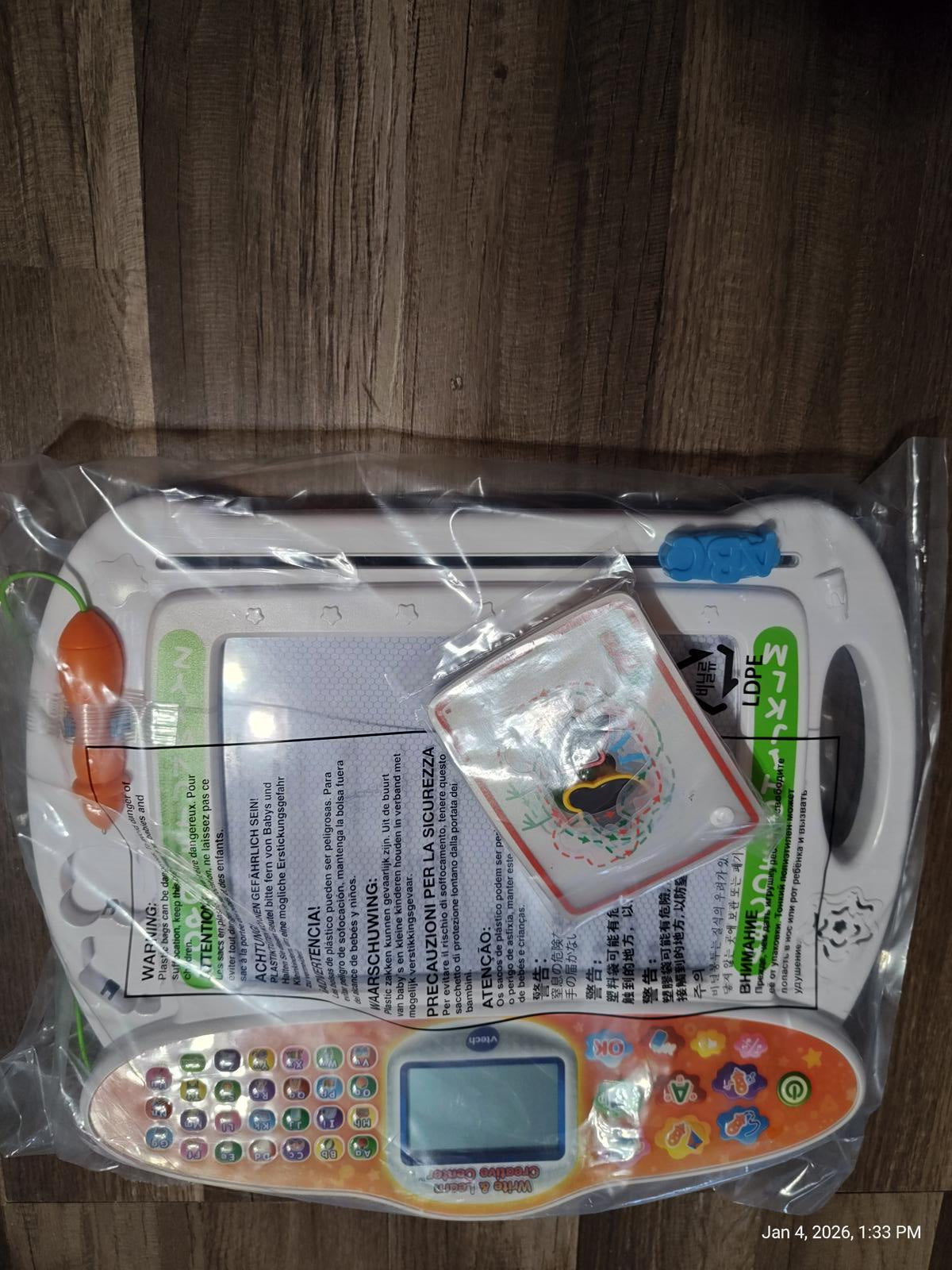 Learning tablet with colorful buttons and educational materials for kids.