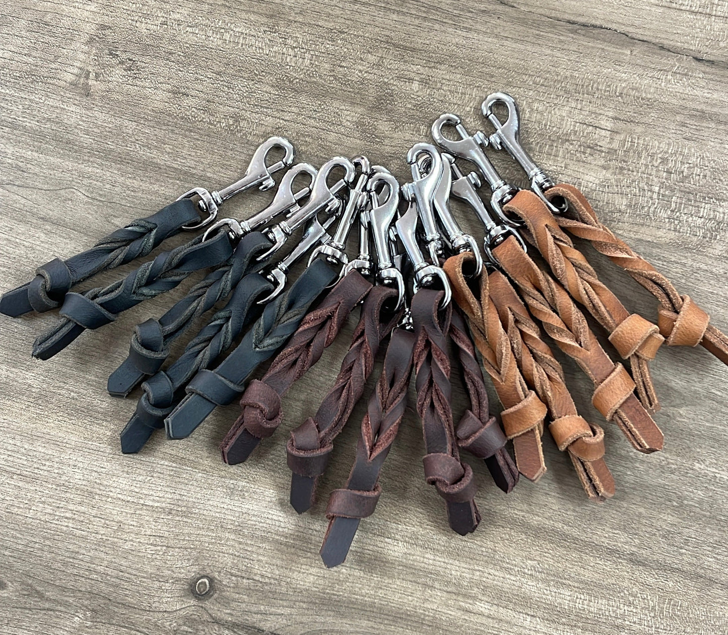 Leather keychain set featuring braided and twisted designs in black, brown, and tan colors.
