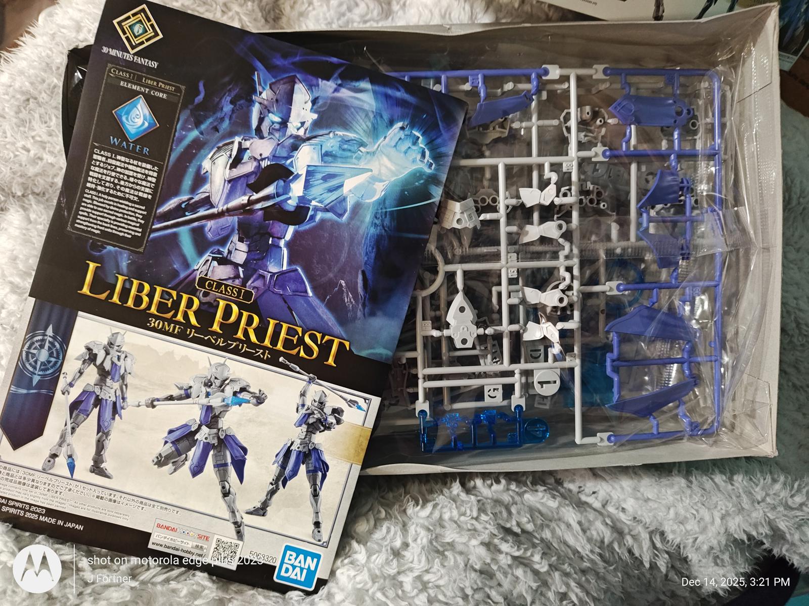 Liber Priest model kit featuring blue and white parts with detailed packaging.