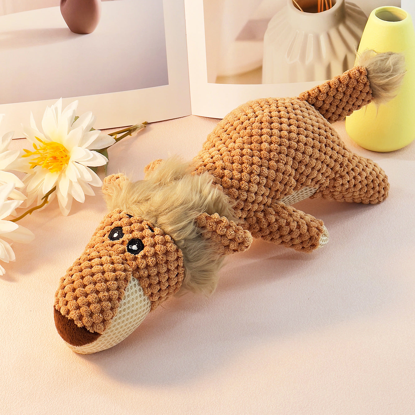 Lion plush toy with textured fabric and cute facial features, perfect for kids.