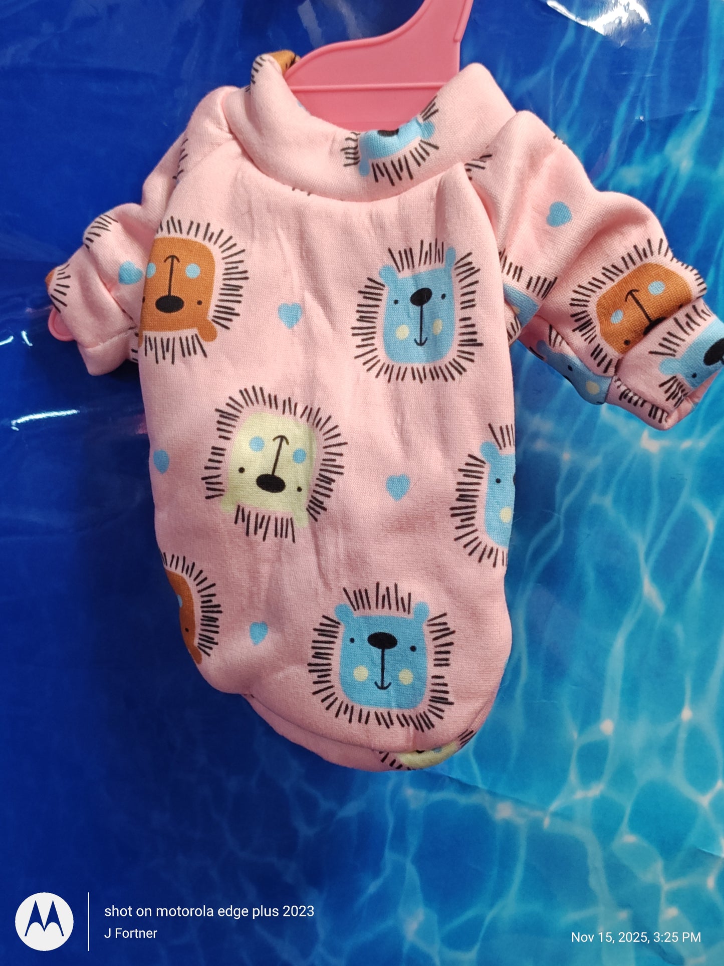 Lion Print Baby Onesie in pink with colorful lion faces and hearts.
