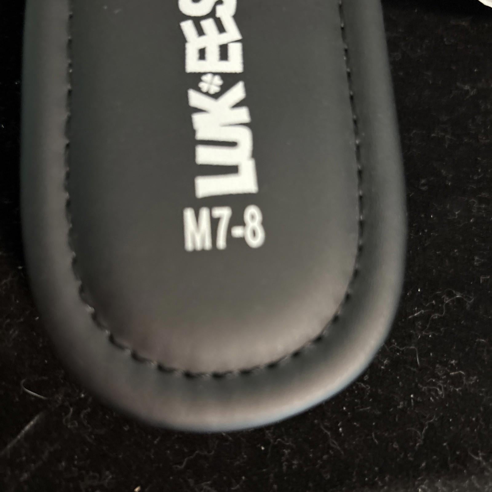 LUK ESS M7-8 black leather case with stitching detail.