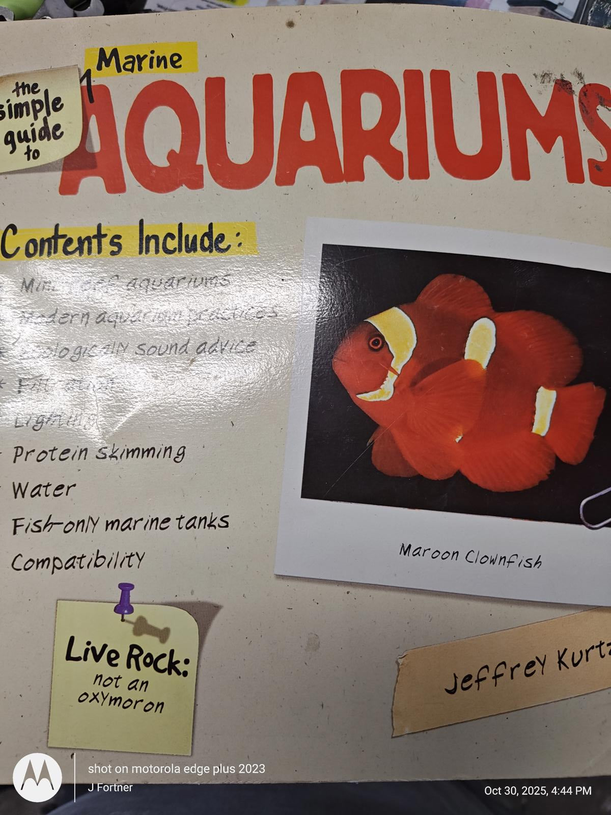 Marine Aquariums book cover featuring clownfish and contents overview.