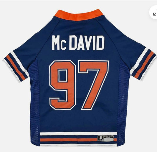 McDavid jersey featuring the number 97 in orange and white on a blue background.