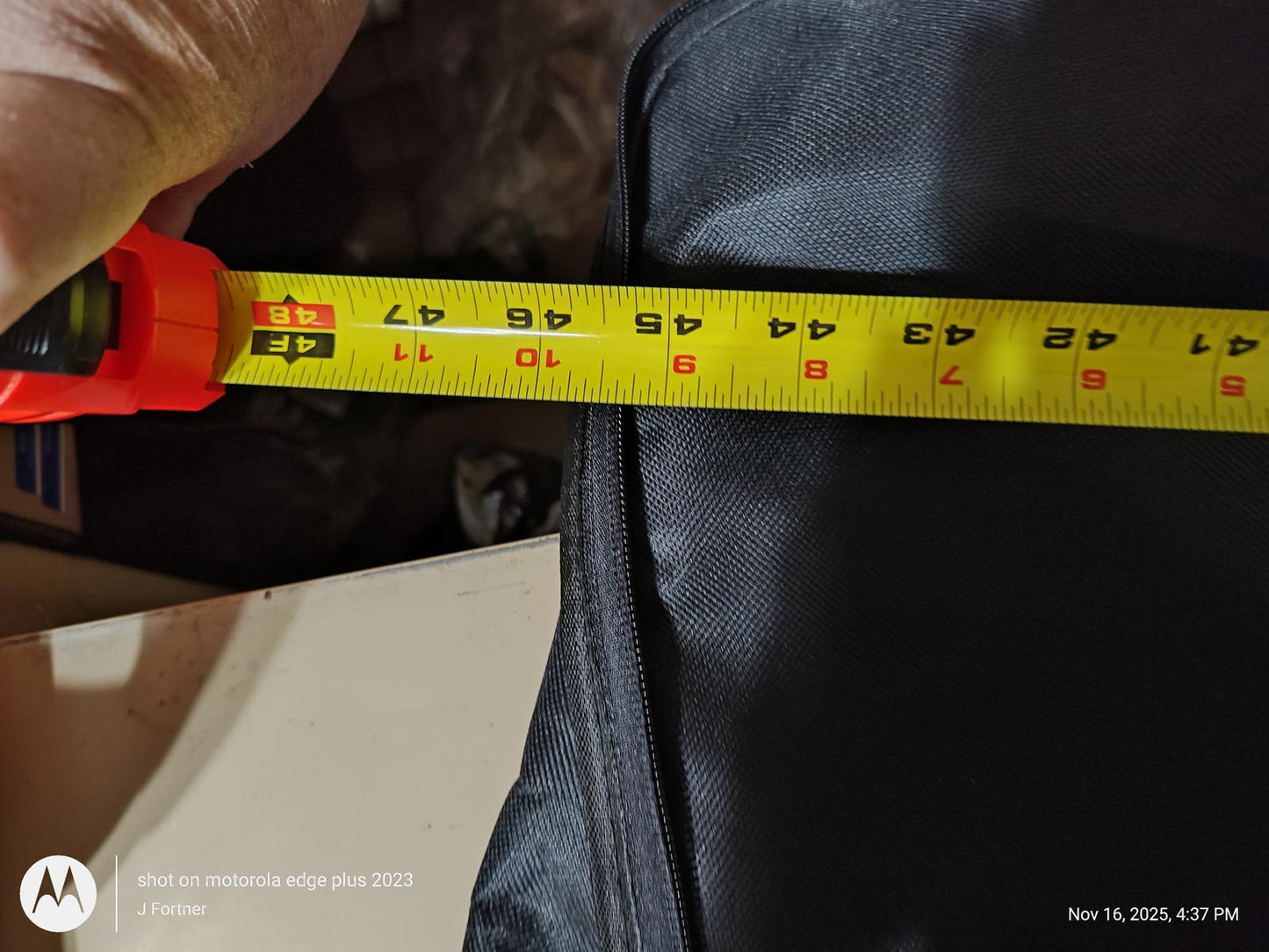 Measuring tape showing 43 inches on a black surface.