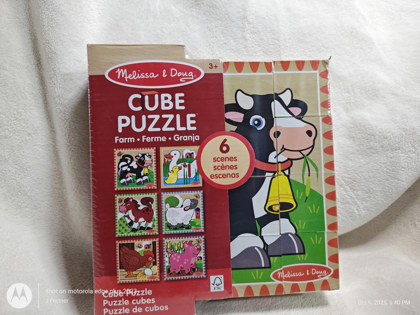 Melissa & Doug Cube Puzzle featuring farm animals with colorful illustrations and a cow design.