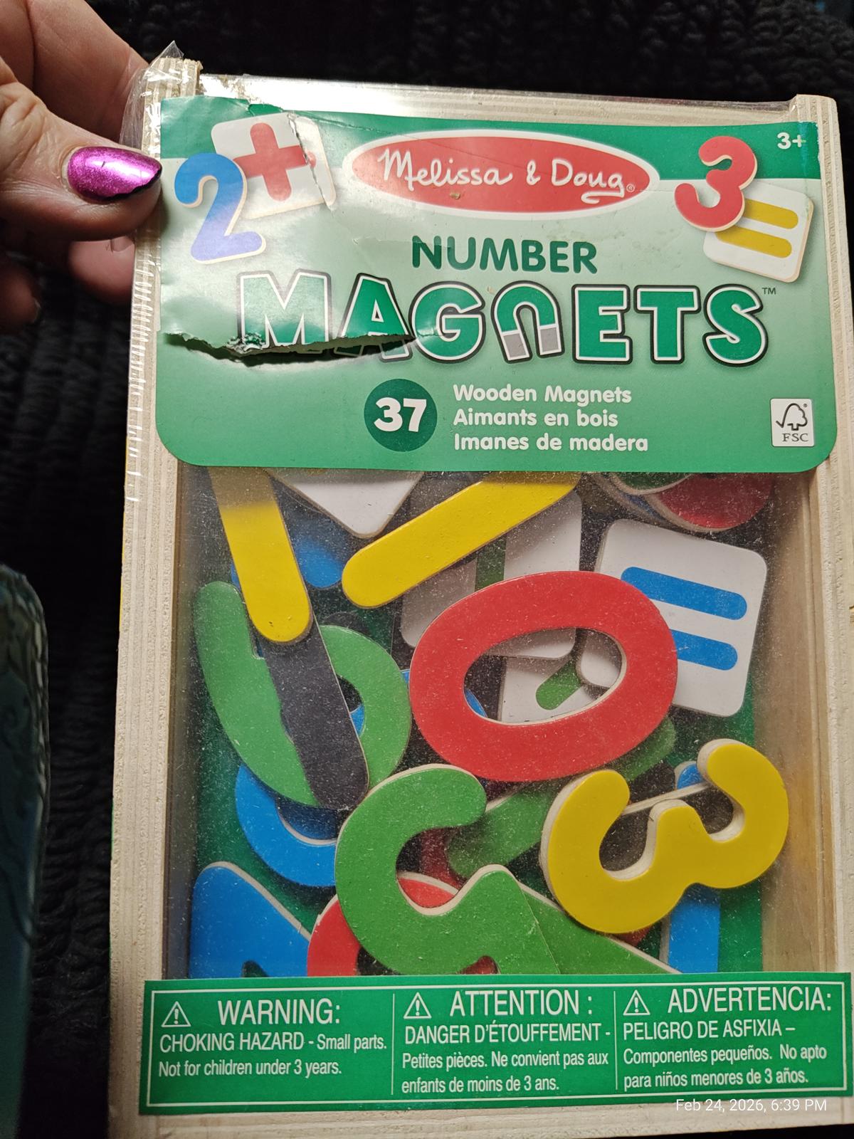 Melissa & Doug Number Magnets set featuring colorful wooden numbers and symbols for educational play.