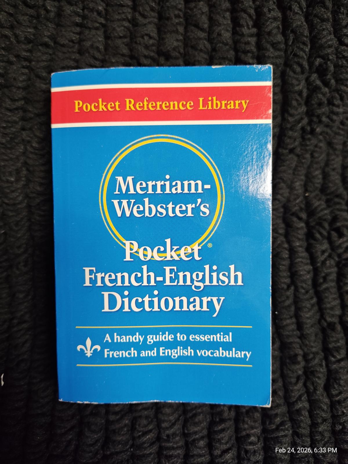 Merriam-Webster's Pocket French-English Dictionary featuring a blue cover and essential vocabulary guide.