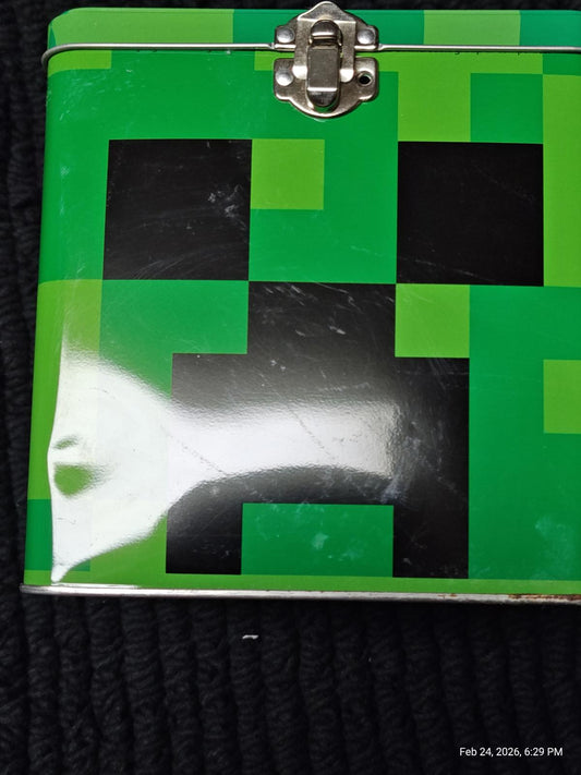 Minecraft Creeper lunchbox featuring a vibrant green and black pixelated design.