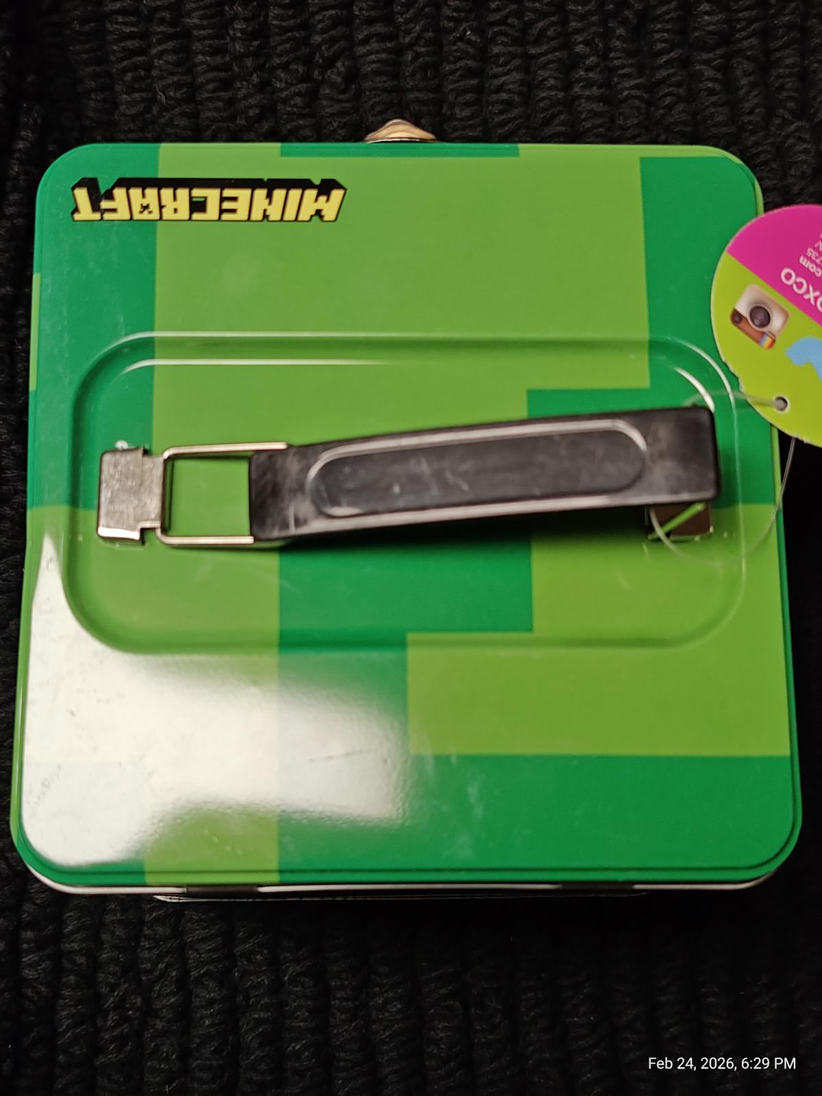 Minecraft-themed tin box with a metal latch and green design.