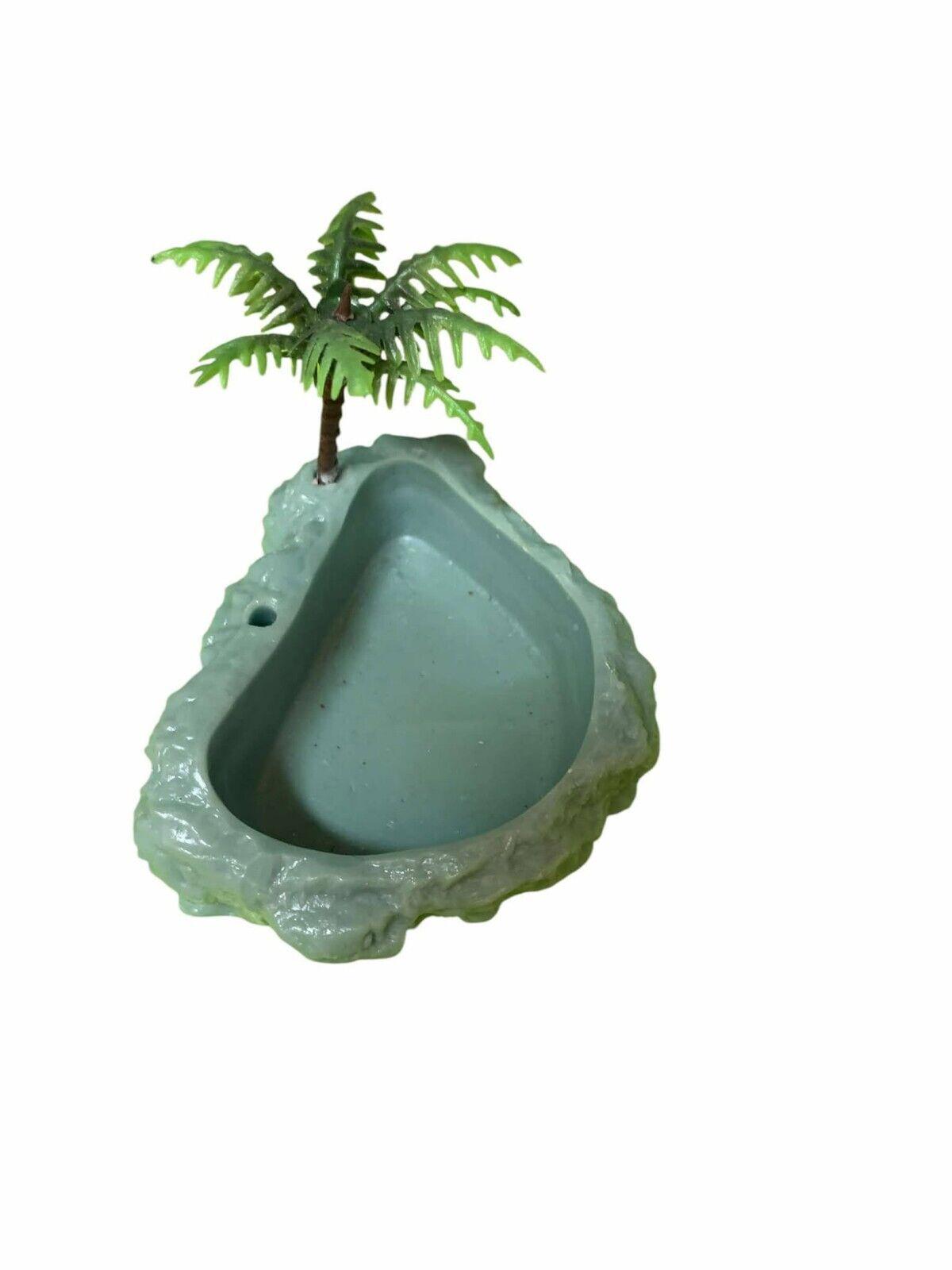 Miniature tropical-themed bird bath with palm tree design.