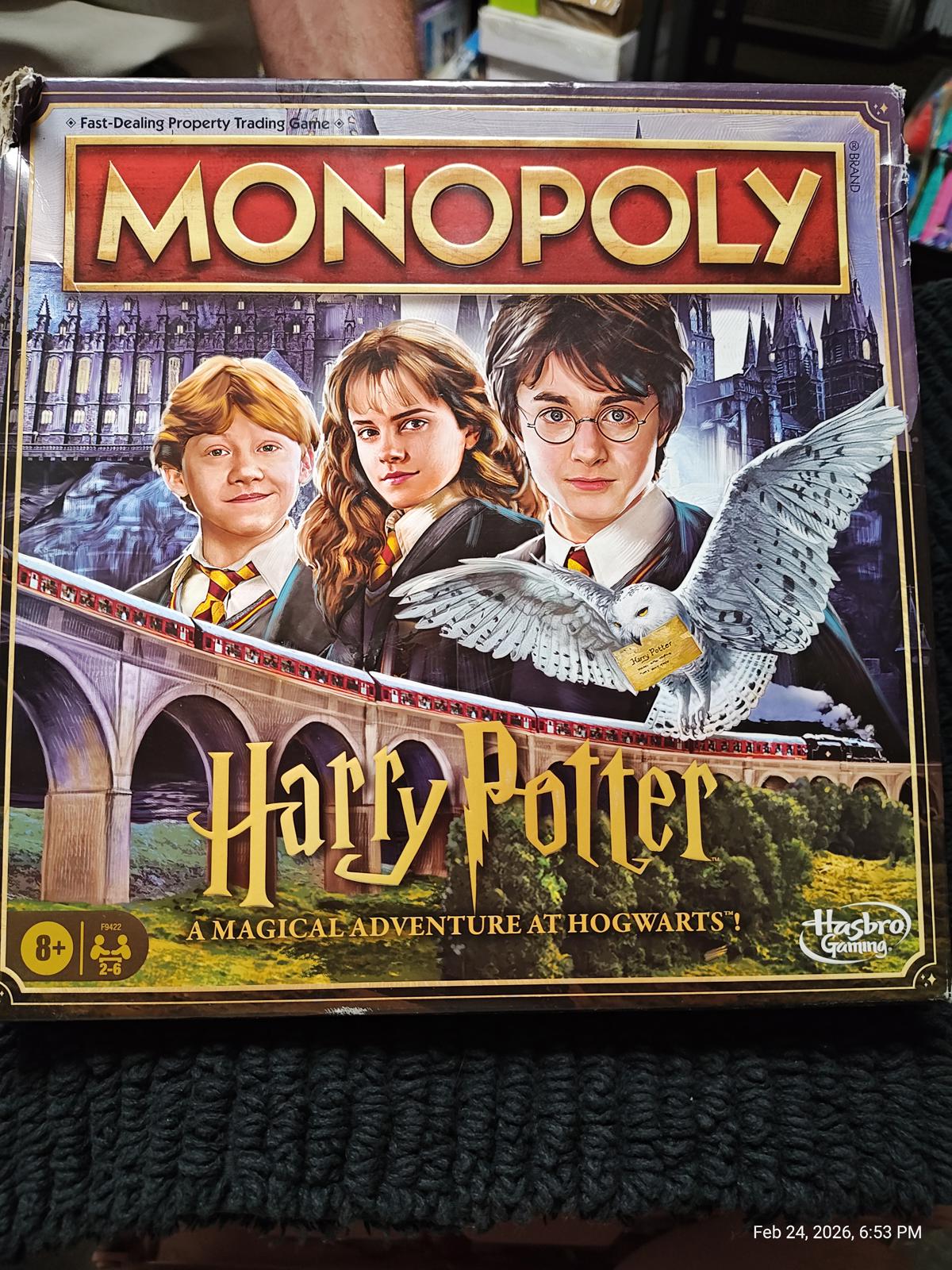 Monopoly Harry Potter board game featuring iconic characters and Hogwarts backdrop.
