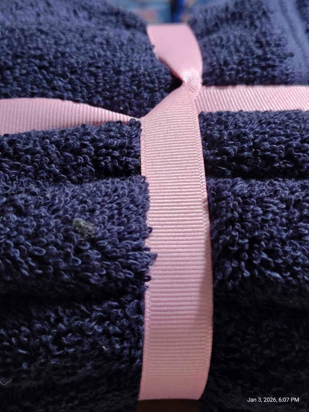Navy Blue Bath Towel wrapped with a pink ribbon, showcasing its soft texture and plush design.