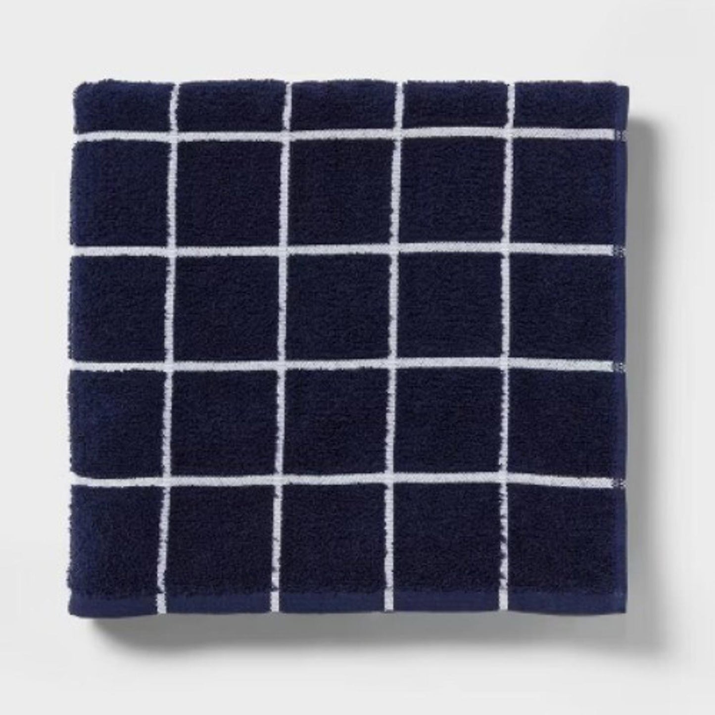 Navy grid-patterned towel with white lines, soft and absorbent fabric.