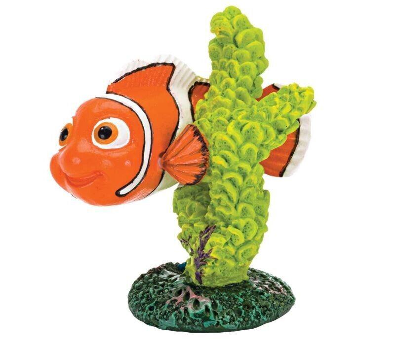 Nemo clownfish figurine swimming among vibrant green coral.