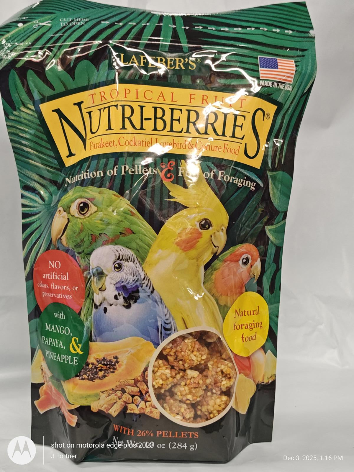 Nutri-Berries Tropical Fruit bird food with mango, pineapple, and colorful pellets for parrots.