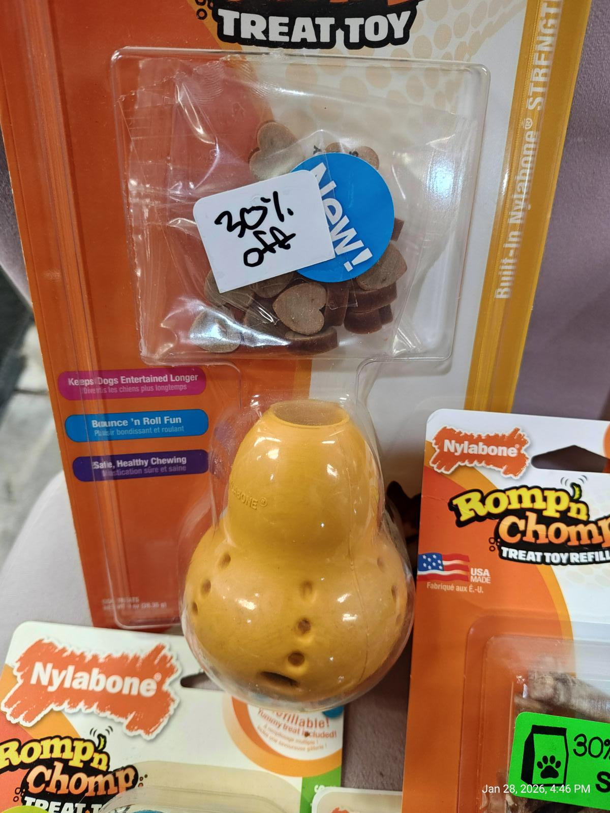 Nylabone Romp 'n Chomp treat toy in yellow with holes for treats, 20% off sticker visible.