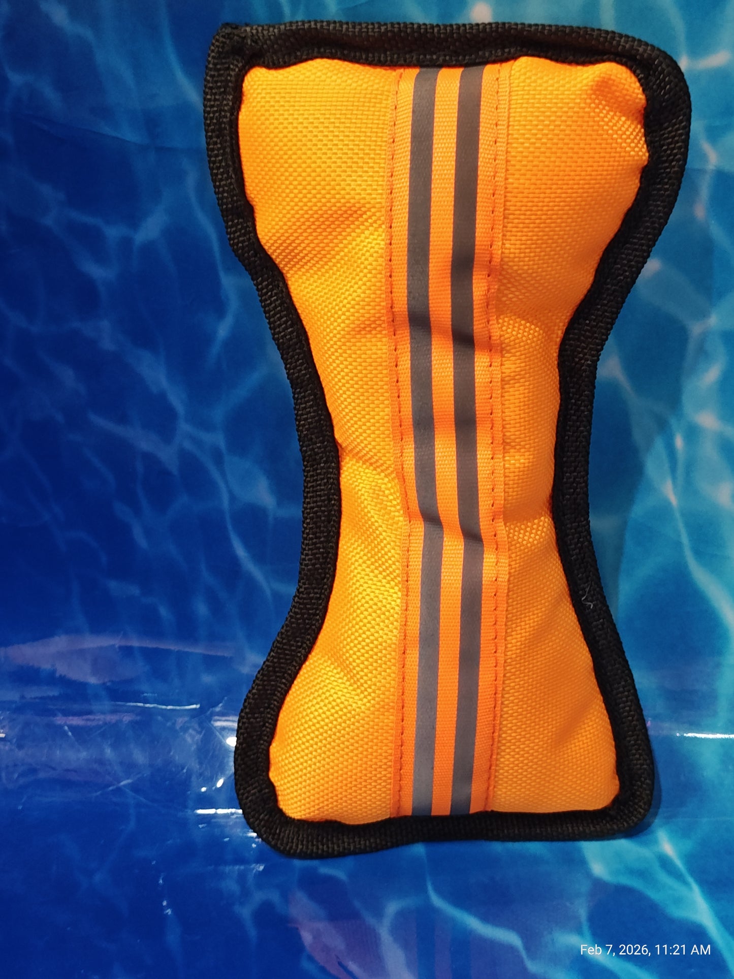 Orange flotation device with black trim and reflective stripes for safety.