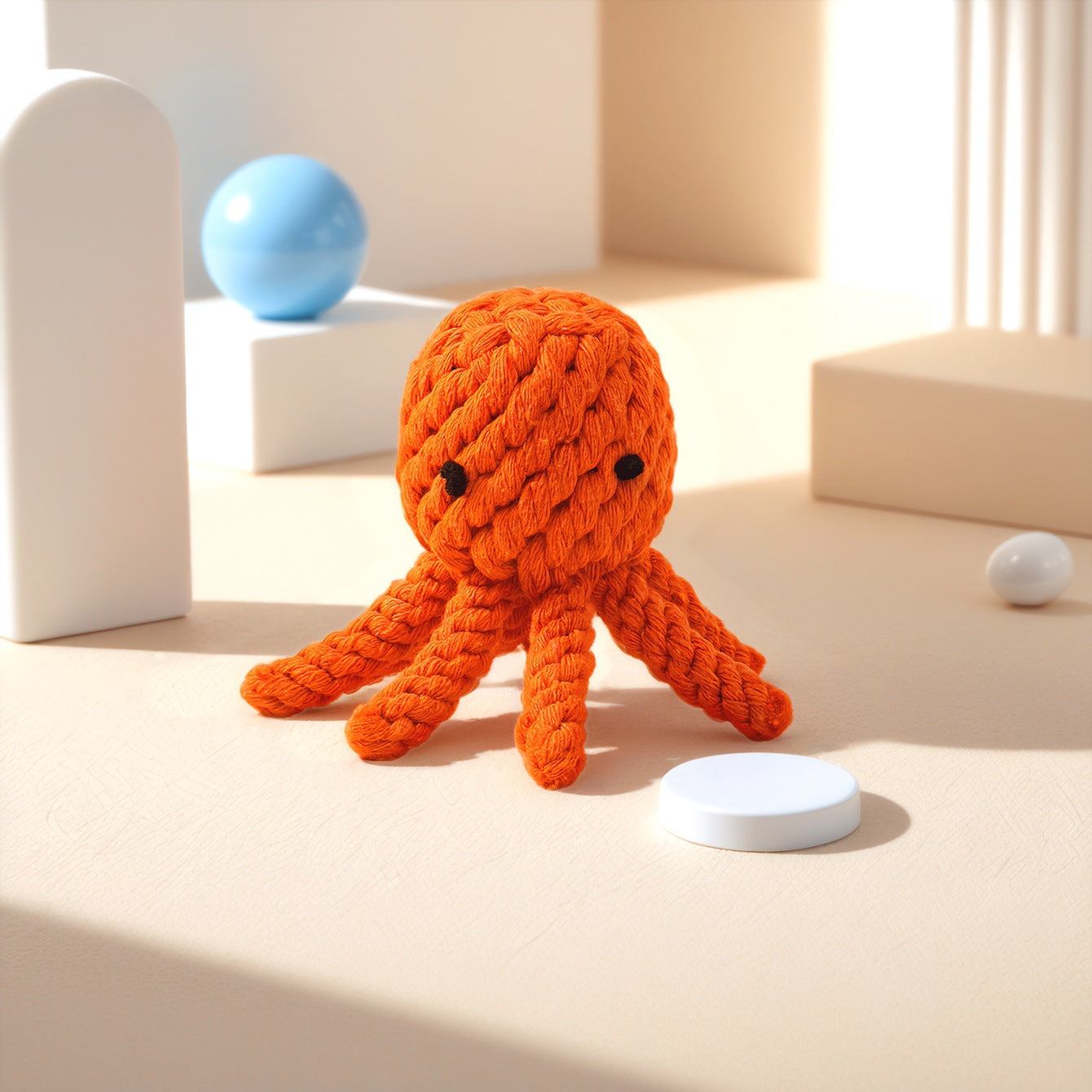 Orange Knitted Octopus toy with eight tentacles, set against a minimalist background.