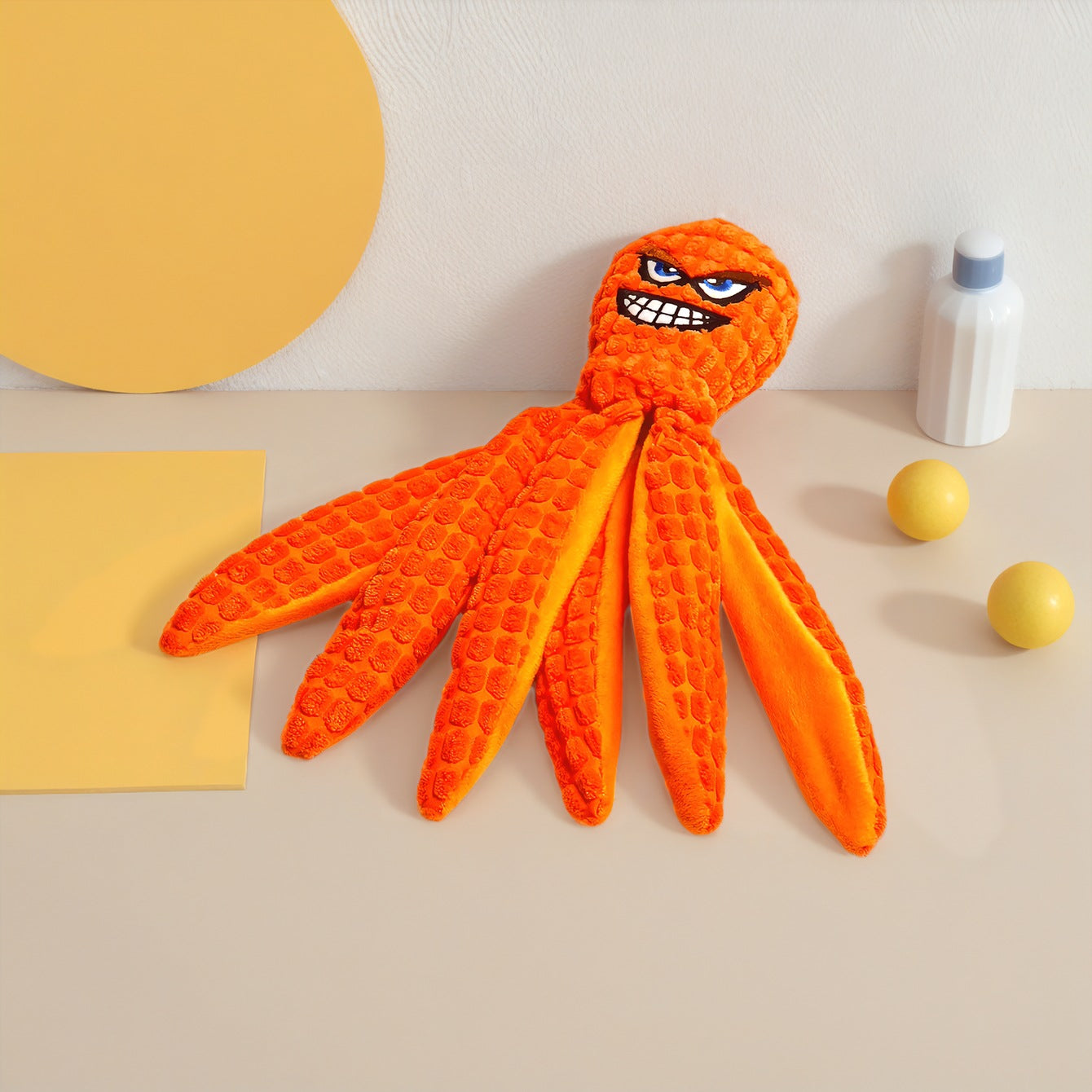 Orange plush octopus toy with a mischievous face and textured tentacles.