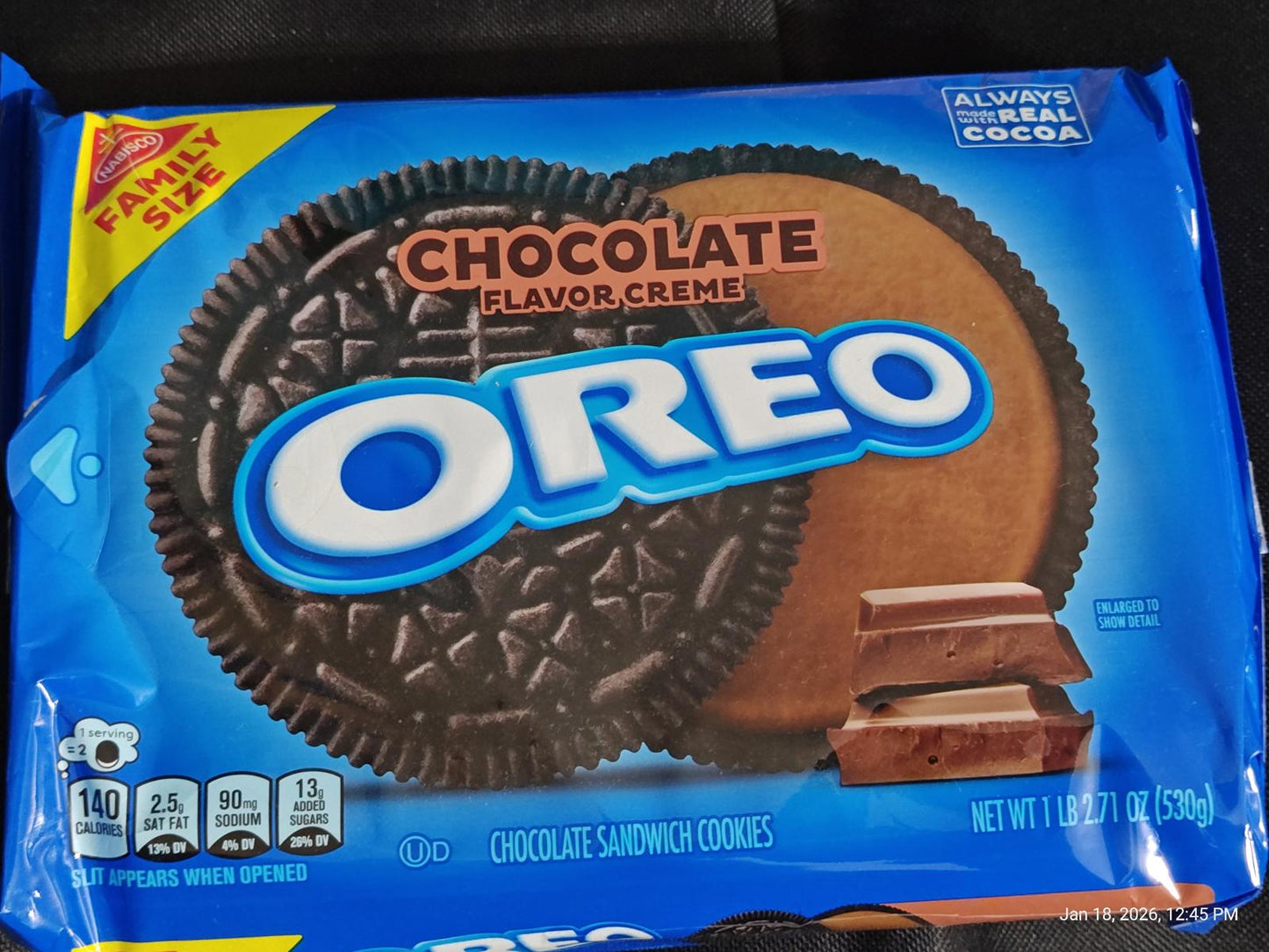 Oreo chocolate flavor crème cookies in family size packaging with chocolate pieces.