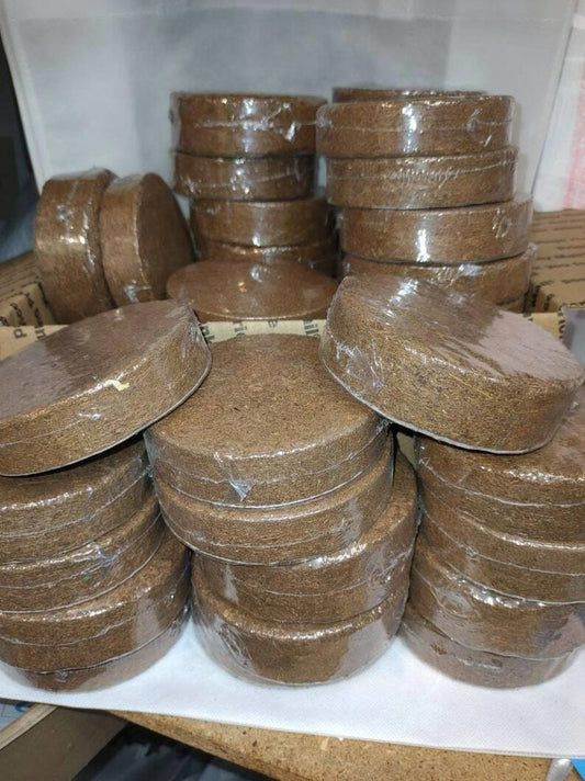 Organic Coconut Coir Discs for gardening, stacked and wrapped in plastic.