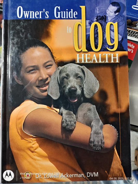 Owner's Guide to Dog Health featuring a woman holding a gray puppy, providing essential pet care tips.