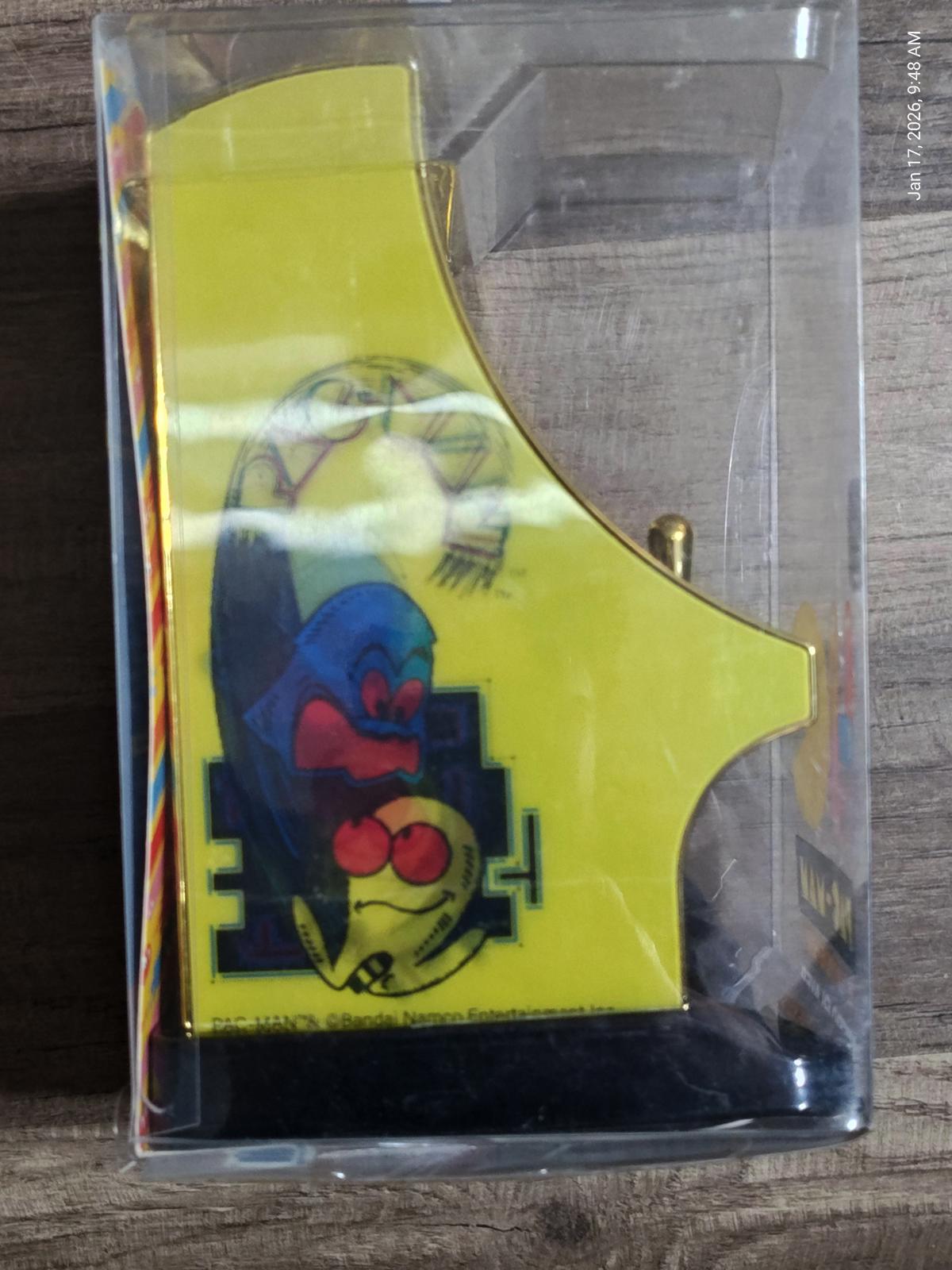 Pac-Man arcade game replica with vibrant yellow design and colorful character graphics.