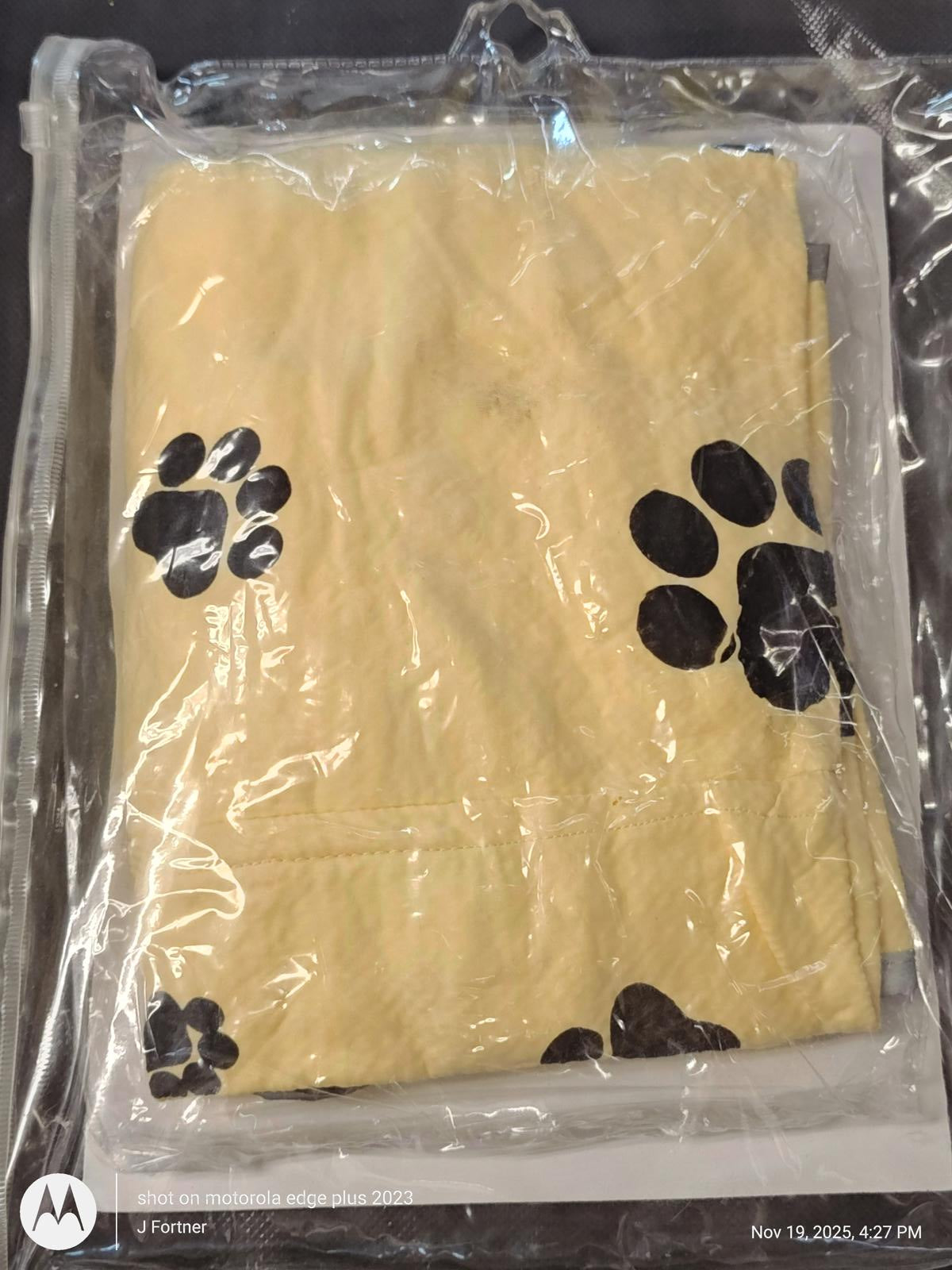 Paw Print Pet Blanket in yellow color, featuring black paw prints on a soft fabric.