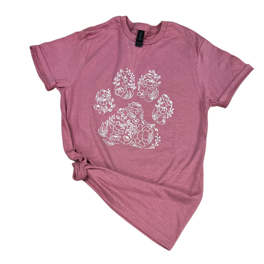 Paw Print T-Shirt featuring floral designs in white on a pink background.