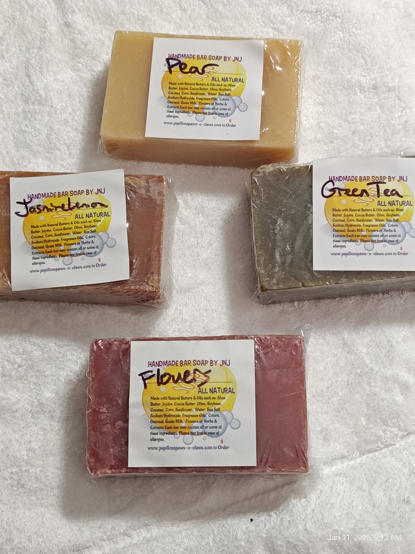 Pear handmade bar soap with natural ingredients, surrounded by Jasmine, Green Tea, and Flowers soaps.