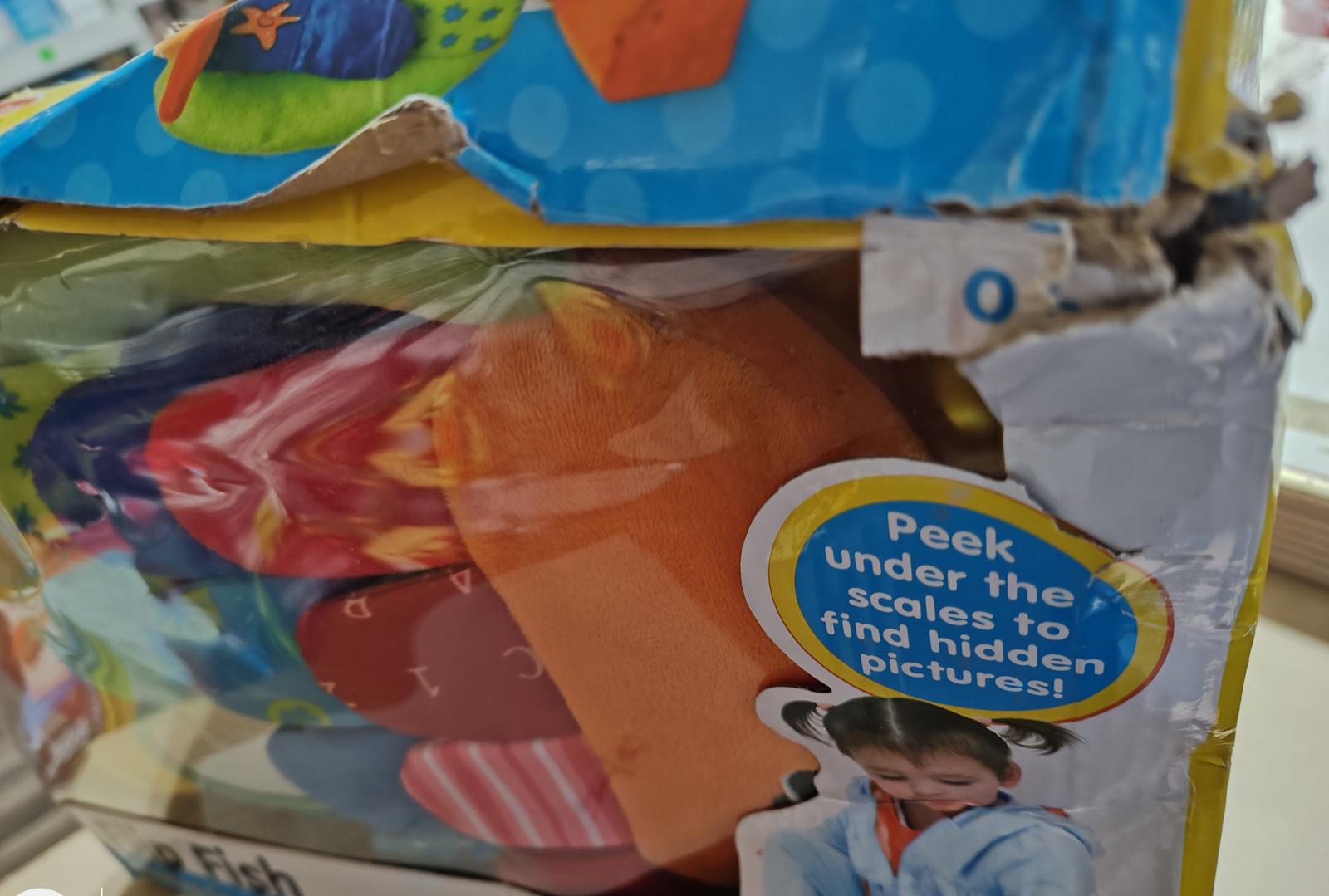 Peek Under the Scales toy packaging showing colorful shapes and hidden pictures.