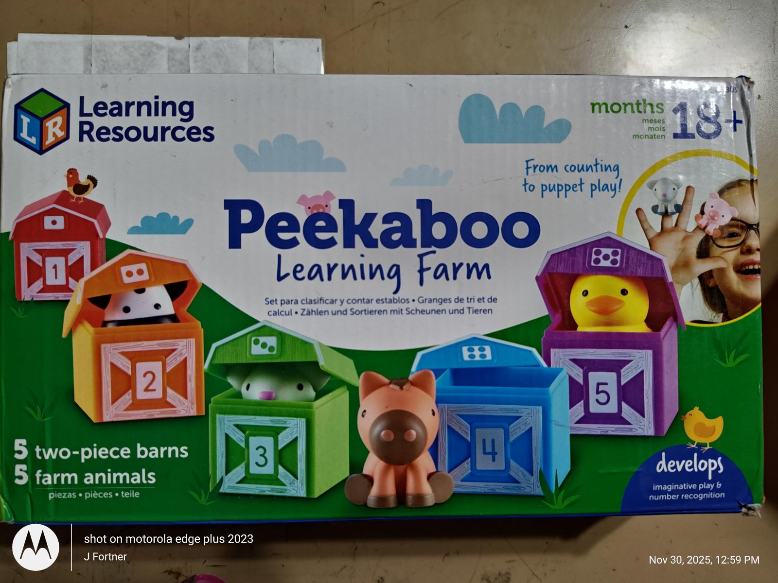 Peekaboo Learning Farm features colorful barns with farm animals for interactive play.