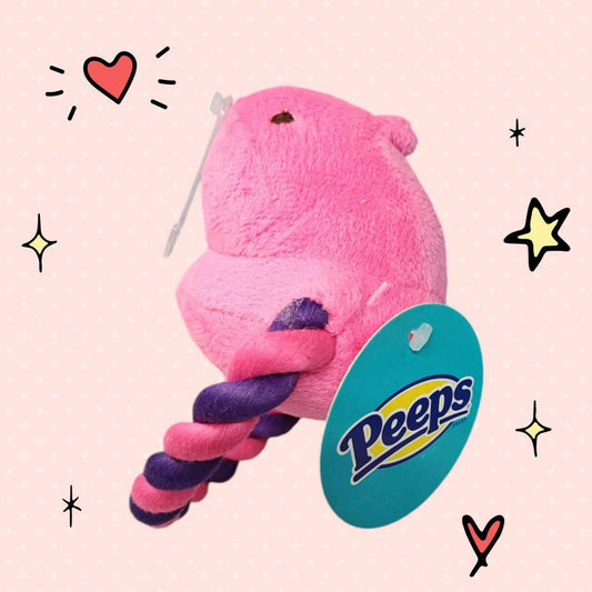 Peeps plush toy in pink with a purple and pink twisted tail.