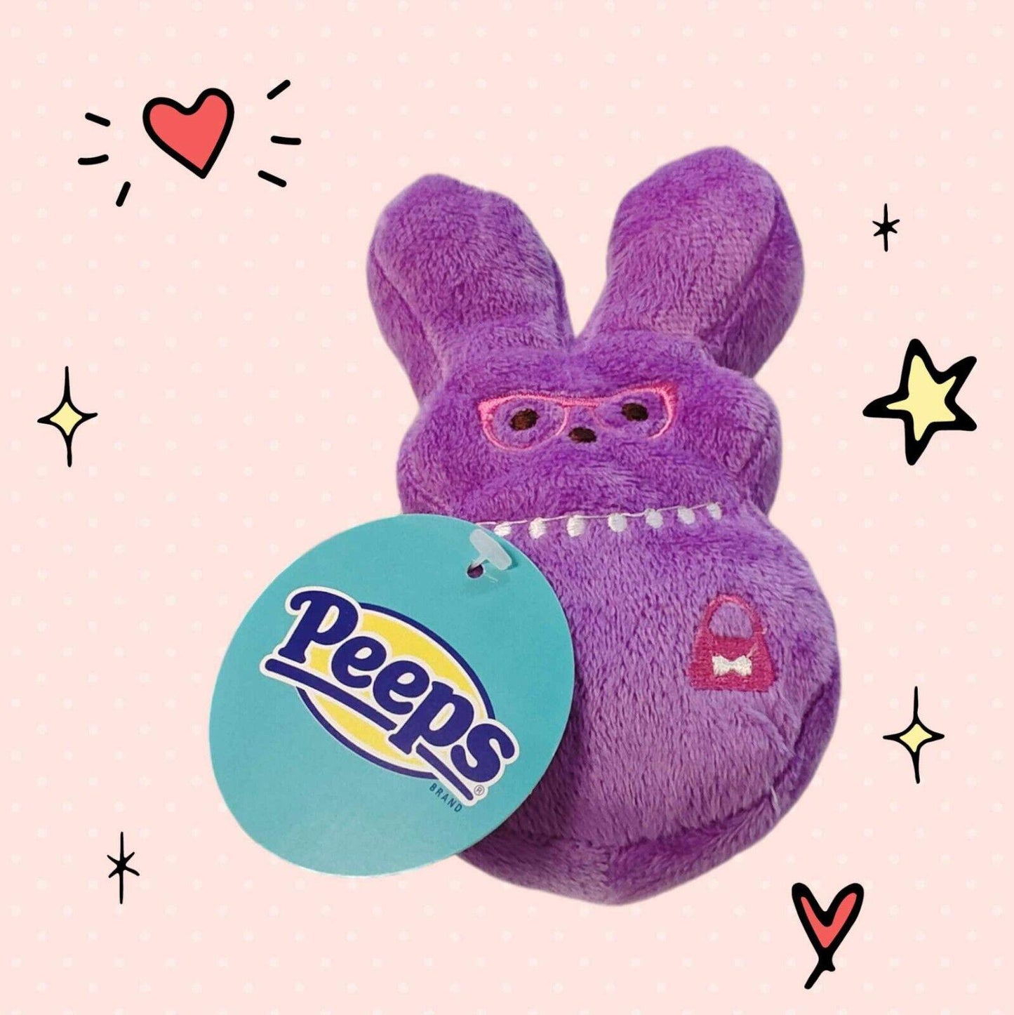 Peeps plush toy in purple color with pink glasses and a tag.