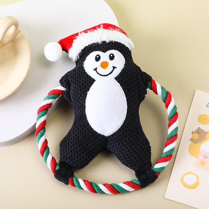 Penguin plush toy with a Santa hat and colorful rope for dogs.