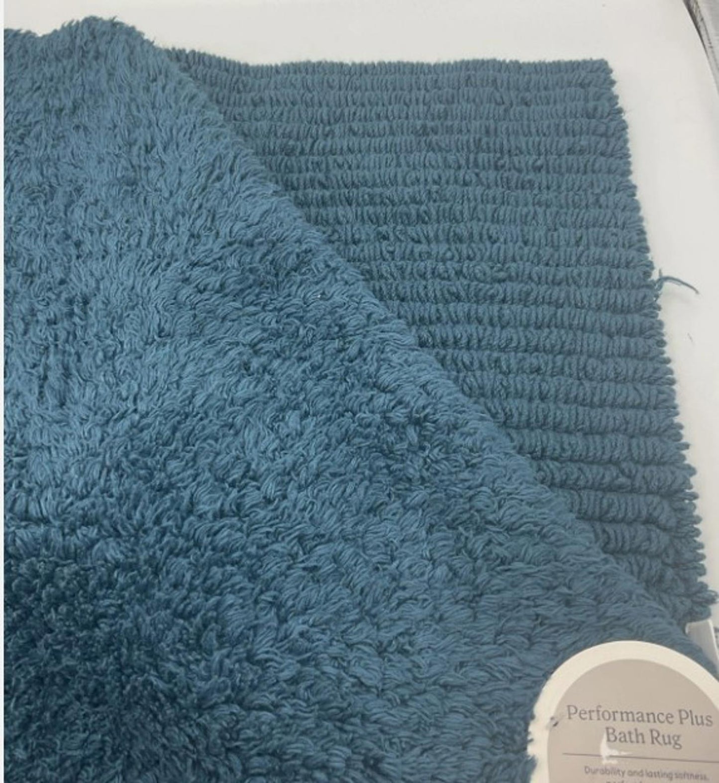 Performance Plus bath rug in teal color featuring plush texture and ribbed design.