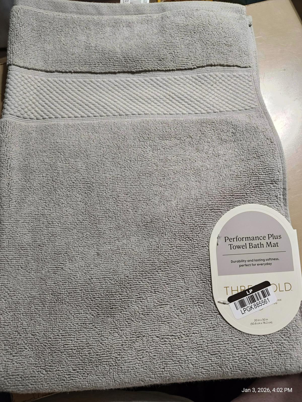 Performance Plus Towel Bath Mat in soft gray color with textured design.