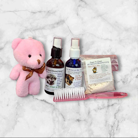 Pet Care Kit with pink teddy bear, grooming spray, and comb for pets.