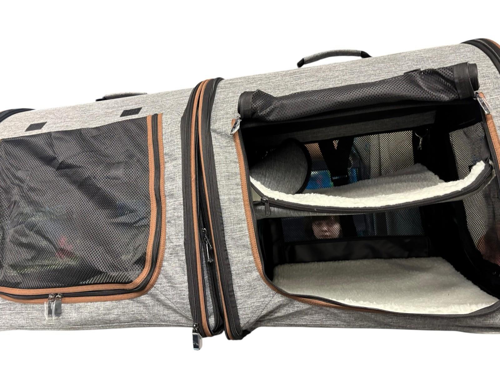 Pet Carrier Bag features spacious compartments and mesh windows for ventilation.
