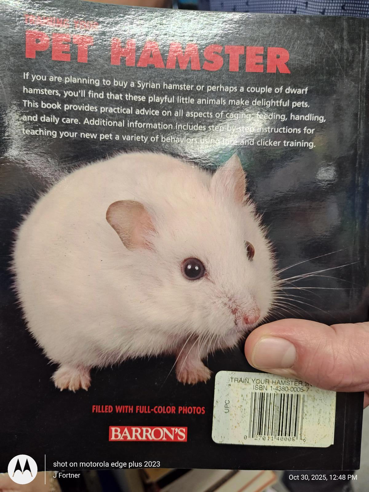 Pet Hamster book cover featuring a cute dwarf hamster, offering care tips and training advice.