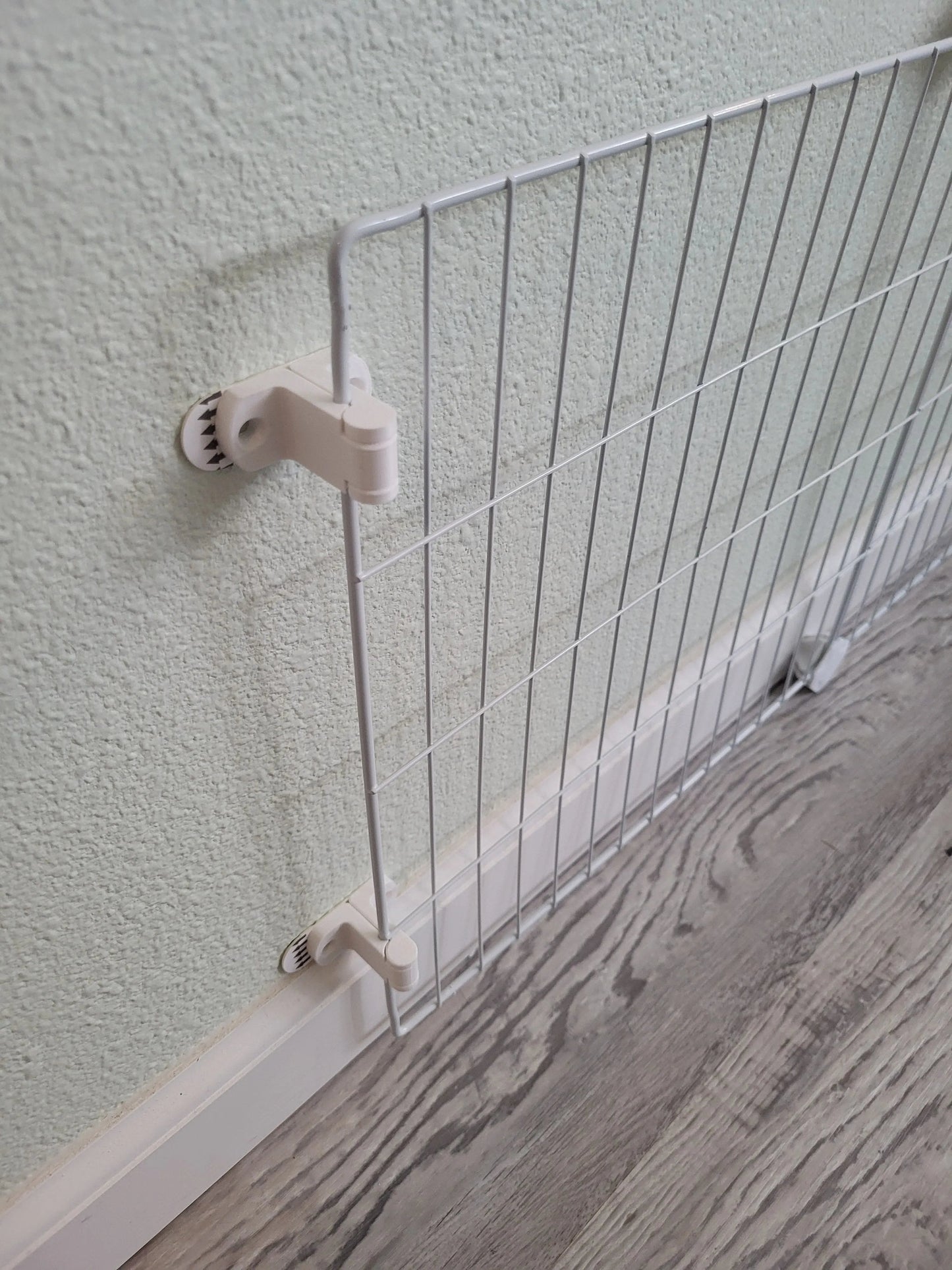 Pet Safety Gate featuring a white metal design, mounted on a wall for secure pet containment.