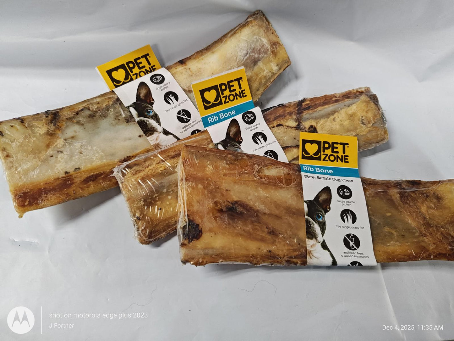 Pet Zone dog bones, natural chew treats for dogs, packaged in clear wrapping.