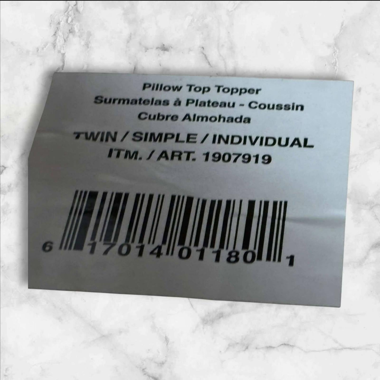 Pillow Top Topper label showing twin size and product details.