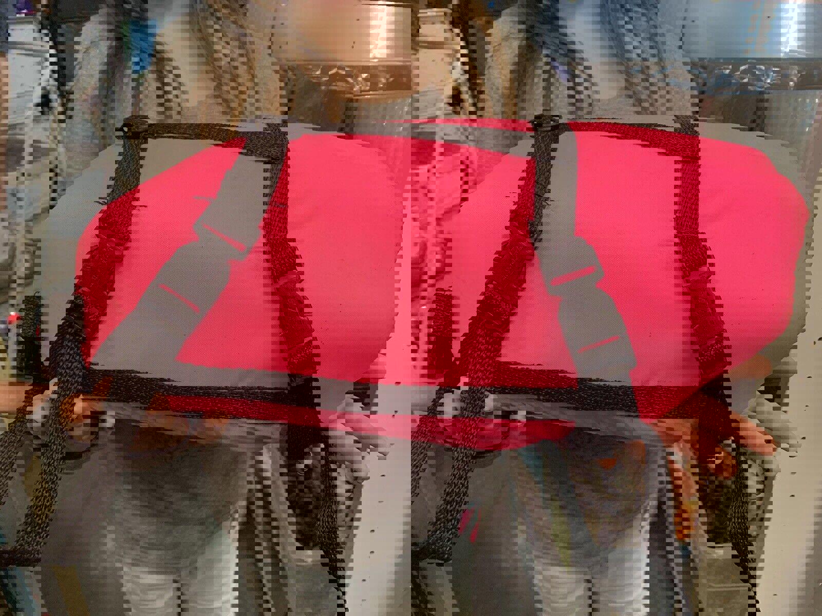 Pink waterproof bag with adjustable straps, ideal for outdoor activities.