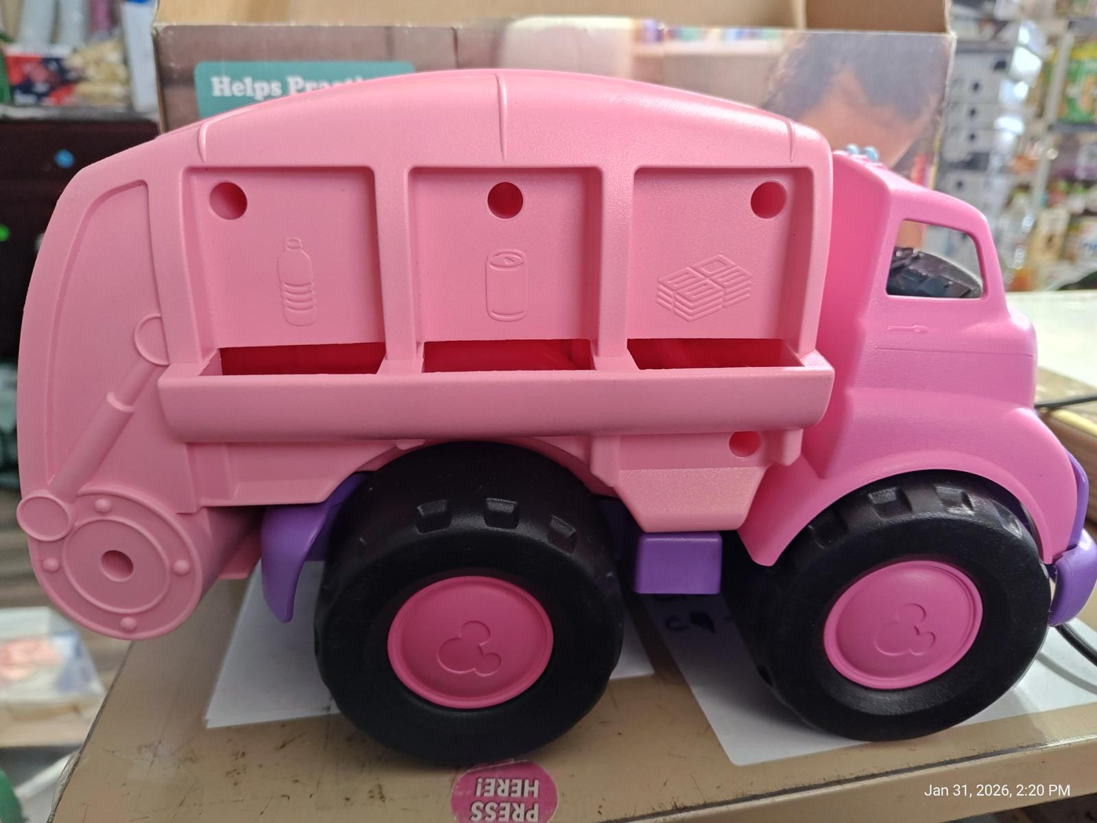 Pink toy garbage truck with three compartments for sorting waste.